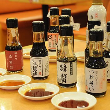Enjoy salmon at a conveyor belt sushi restaurant with soy sauce 5 bottles